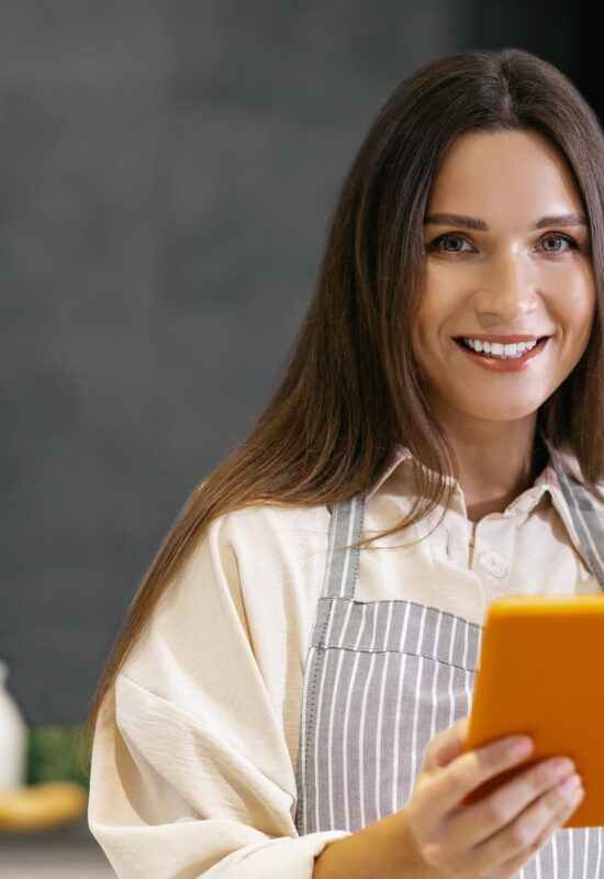 Long-haired young woman thinking about cooking something for lunch